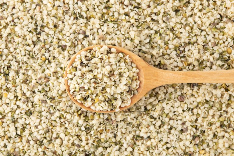 hemp seeds background with wooden spoon